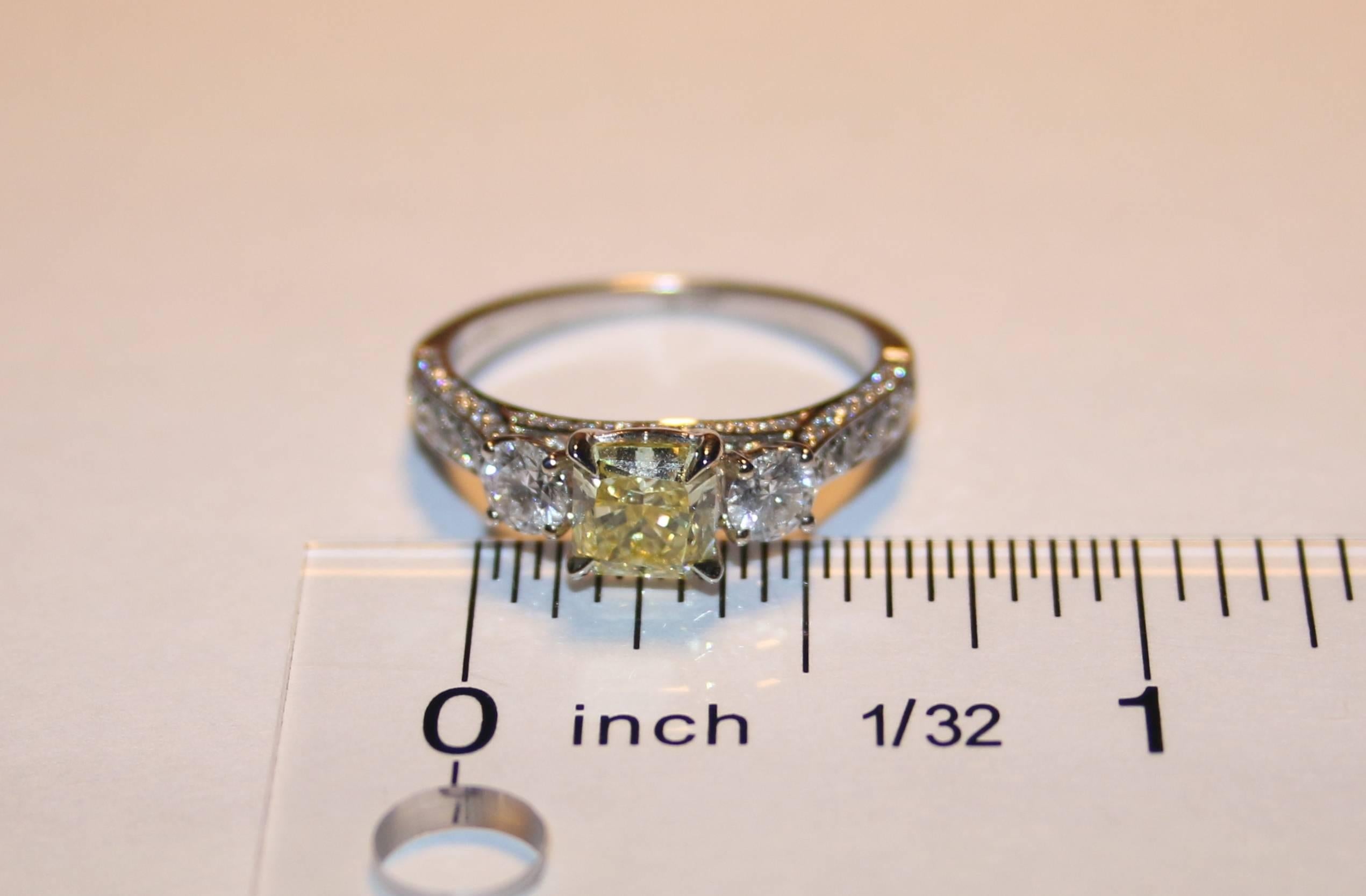 Radiant Cut GIA Certified 0.91 Carat Fancy Intense Yellow Diamond Three Stone Gold Ring For Sale