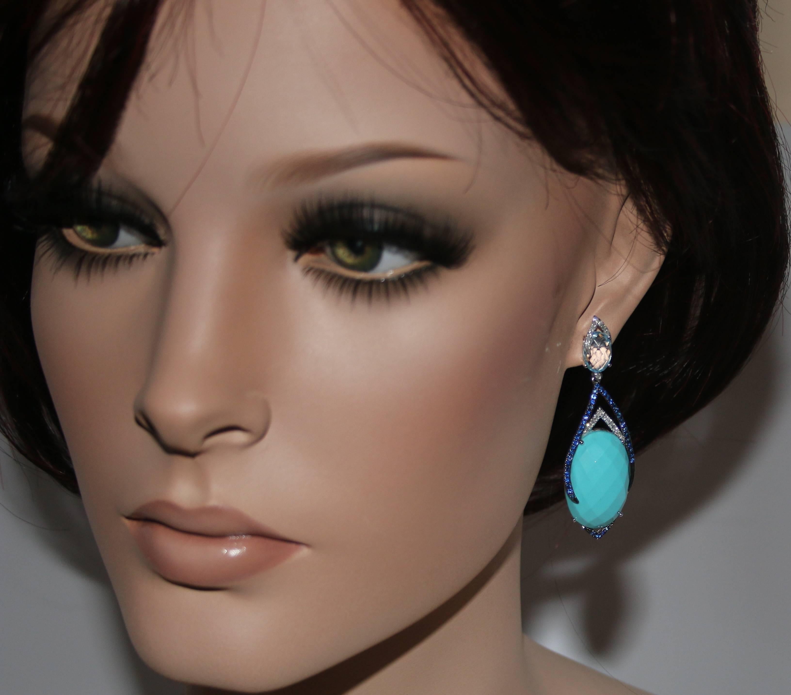 Stunning Turquoise Drop Earrings
The earrings are 14K White Gold
There are 0.33 Carats In Diamonds G/H SI
There are 0.82 Carats Blue Sapphires
There are 4.00 Carats Blue Topaz
There are 34.95 Carats Reconstituted Blue Turquoise
The earrings are