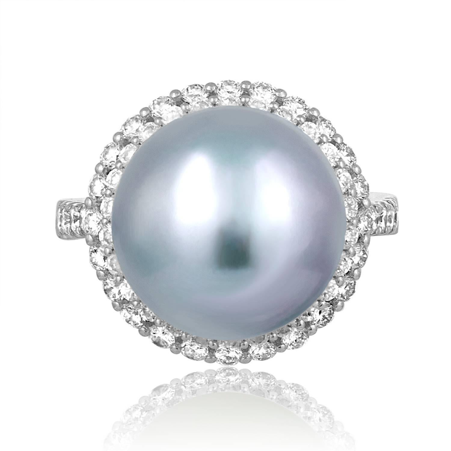 Very Unusual Color Pearl Ring
The ring is 18K White Gold
There are 1.18 Carats In Diamonds F/G SI
The ring has a 14mm South Sea Pearl
The pearl is Bluish Pink in Color
The pearl changes color depending on the light.
The ring weighs 9.0