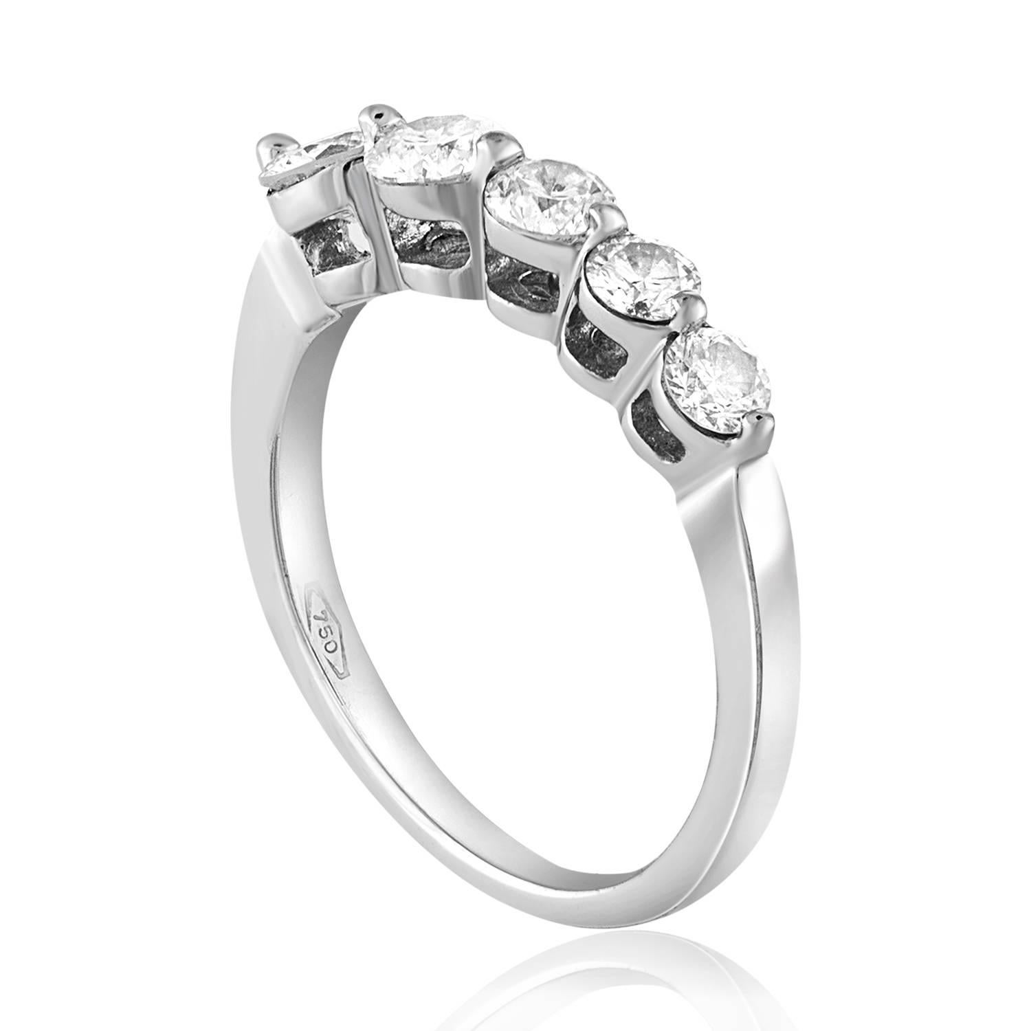 Very Beautiful Graduating Diamond Half Band Ring
The ring is 18K White Gold
There are 5 Round Cut Diamonds prong set
There are 0.70 Carats Total in Diamonds E VS
The ring is a size 4.75, sizable. 
The ring weighs 2.6 grams.
