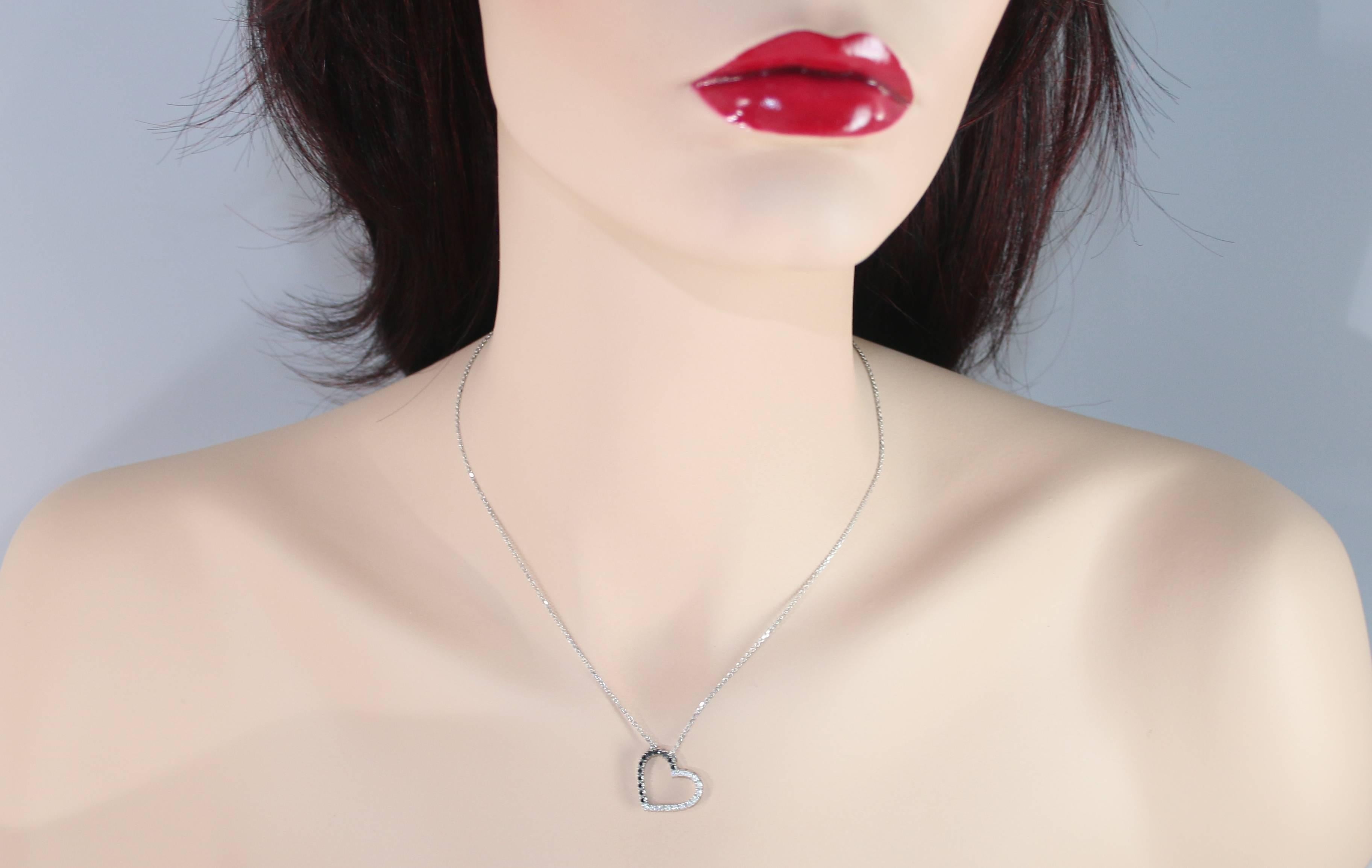Very Delicate Heart Necklace.
The chain and pendant are both 14K White Gold.
There are 0.25 Carats in White Diamonds G/H I1.
There are 0.25 Carats in Black Diamonds.
The pendant measures 0.75
