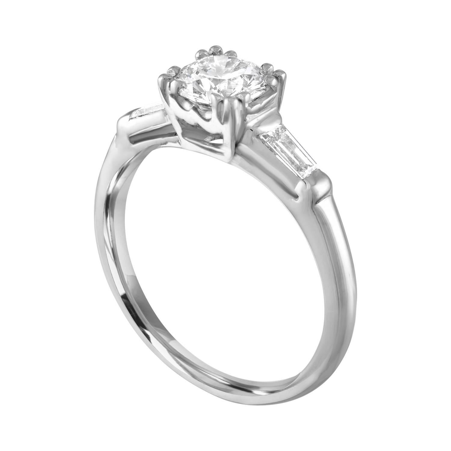 Round Shape Engagement Ring.
The ring is Platinum.
The center Stone is a Round 0.74 Carats I SI1.
There are 2 Tapered Baguettes 0.40 Carats H VS.
The ring is a size 6.00, sizable.
The ring weighs 3.4 grams.