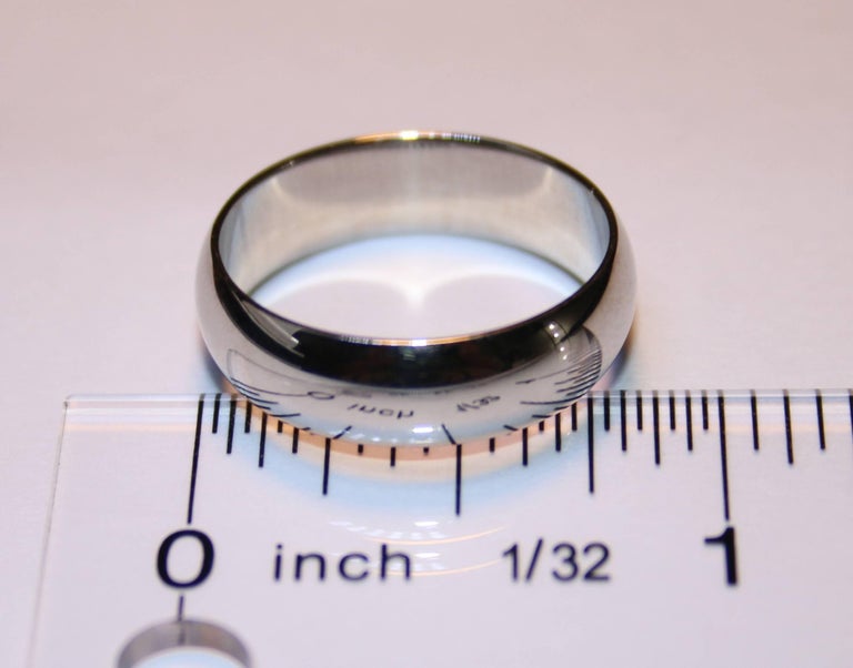 The wedding band is 18K White Gold.
The band is 6.0mm wide.
The ring is a size 9, sizable.
The ring weighs 6.1 grams