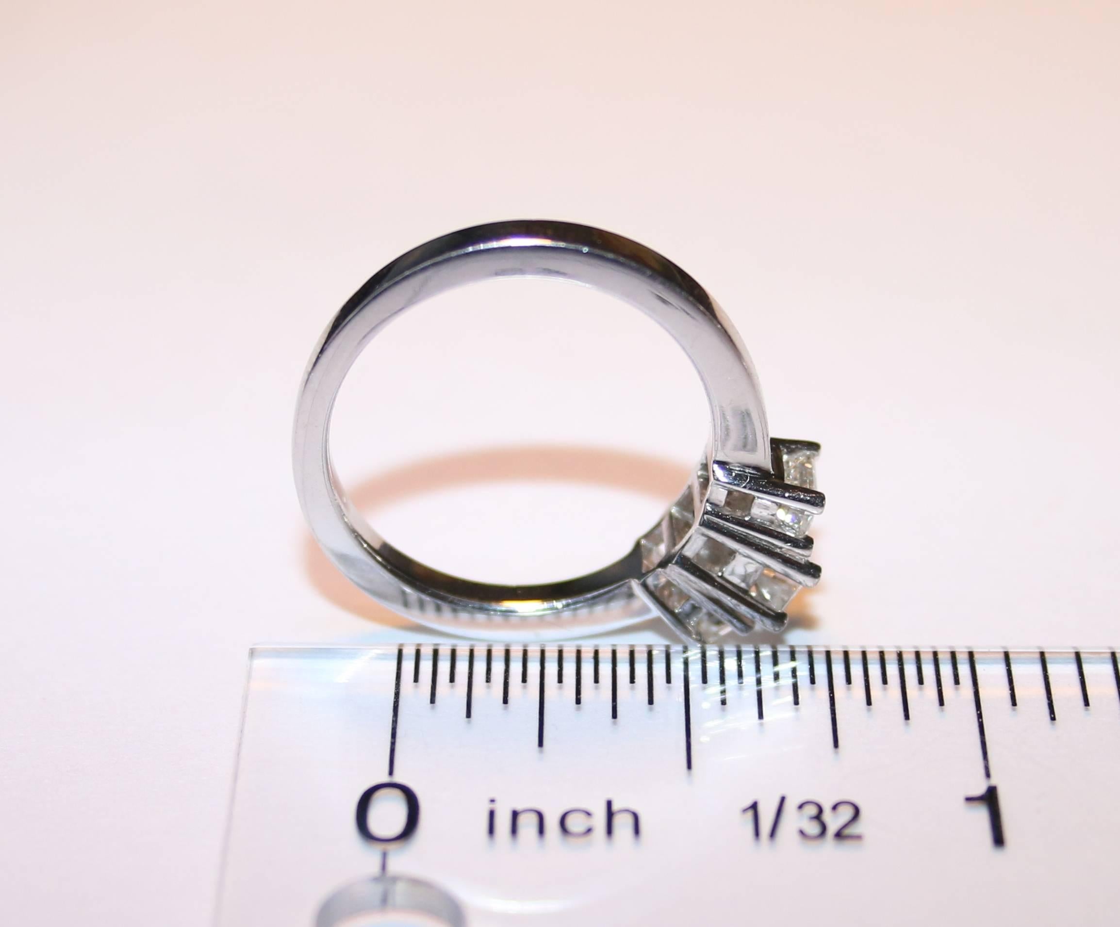Women's 0.90 Carat Emerald Cut Diamond Three Stone Platinum Ring For Sale