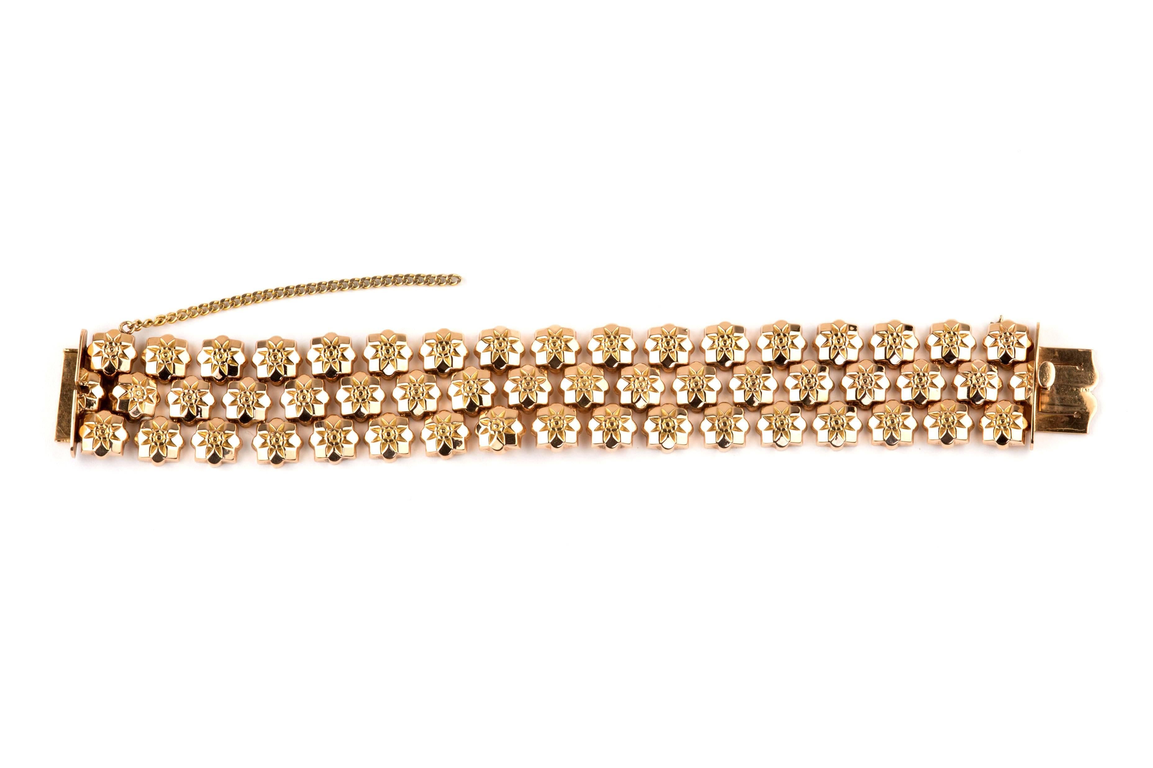 This fabulous Retro rose gold bracelet features 3 rows of textured floral links that  measure 1 inch in width. Textured on the outside, the inside of the links is smooth, and the bracelet measures 7 inches in length. 