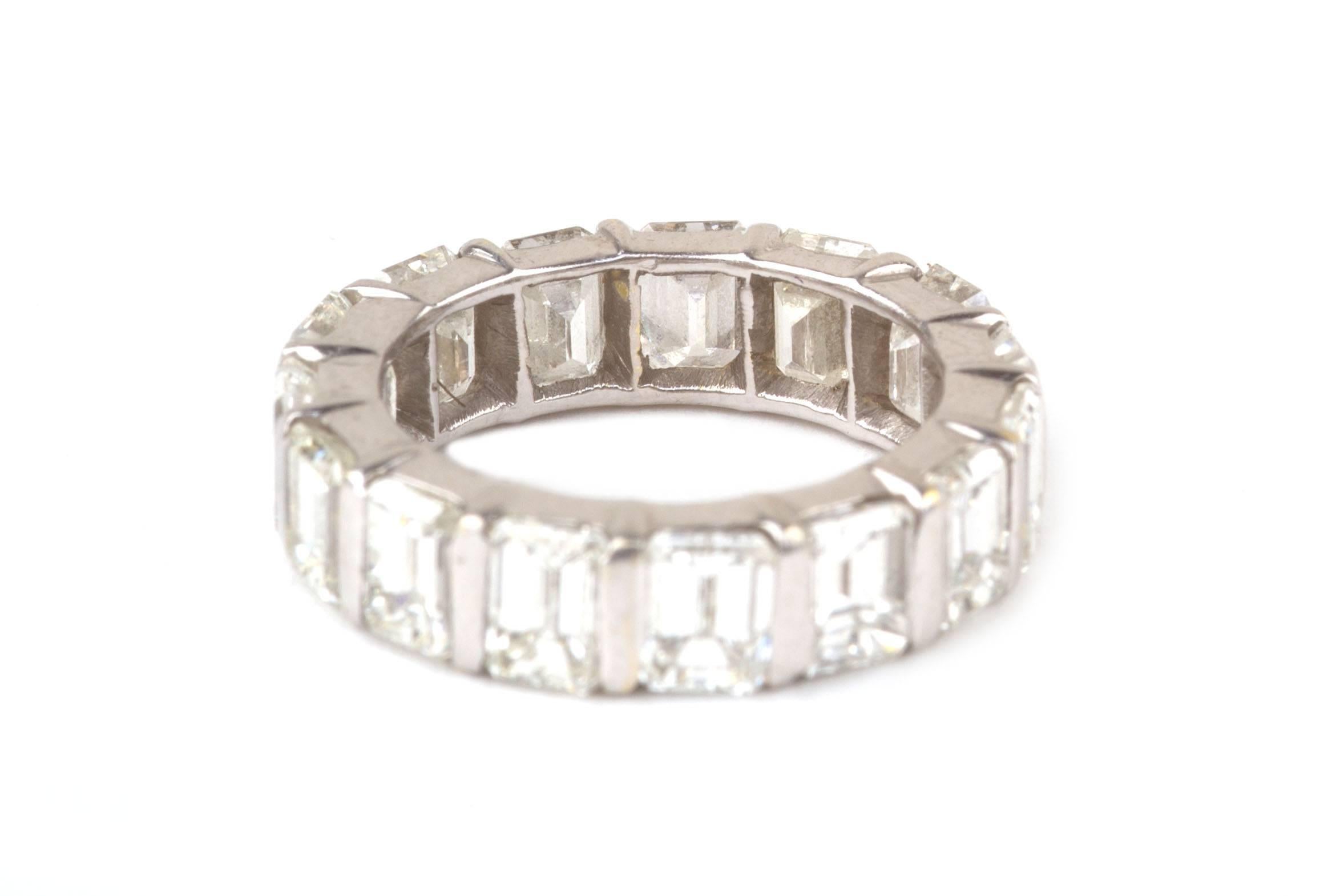 This radiant diamond eternity band features 15 emerald cut diamonds in a channel prong setting. The 15 diamonds equal approximately 7 1/2 carat total weight, and measure 12.5-13mm in width.  The diamonds are graded approximately G-H color and VS