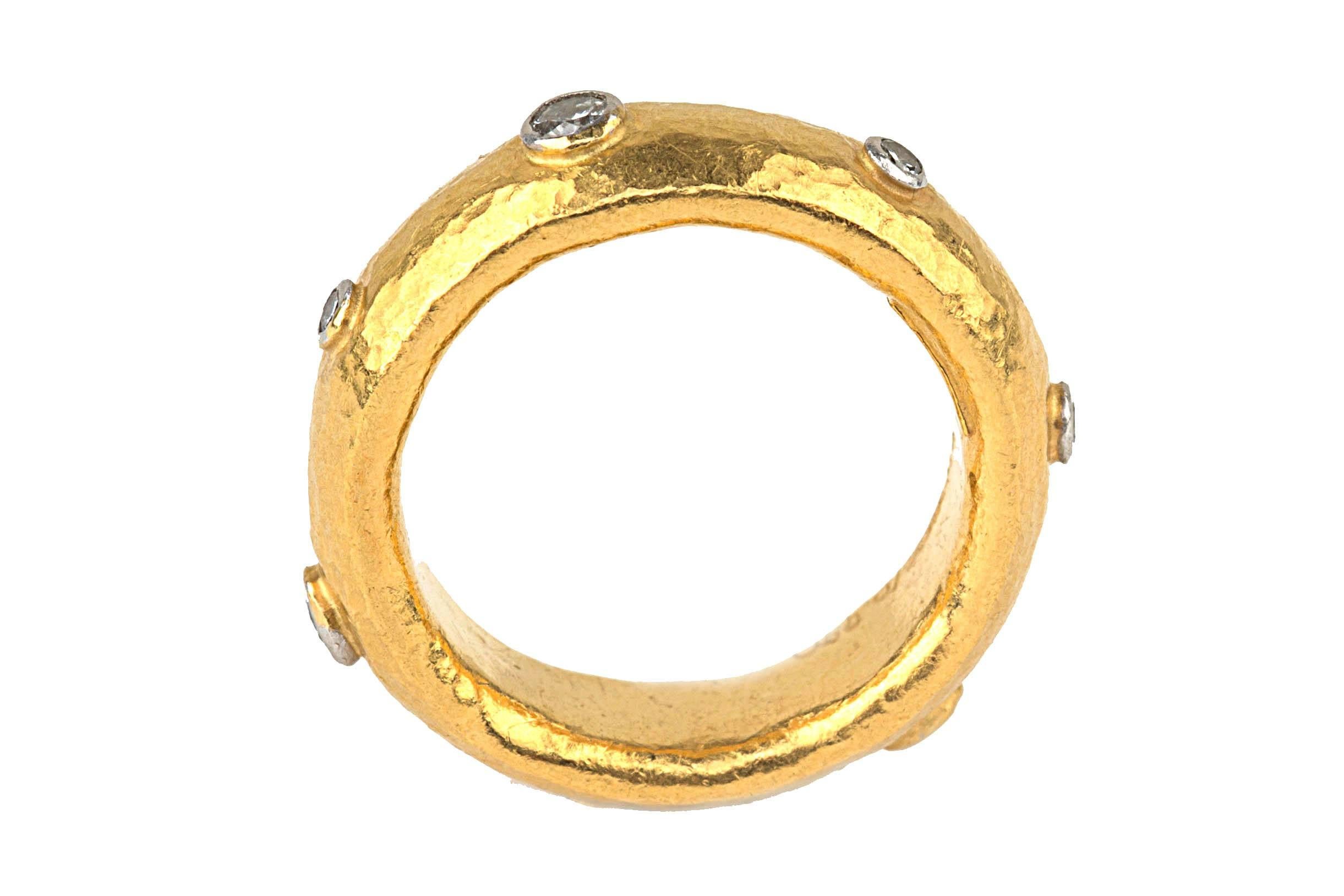 Radiant 22 karat hammered yellow gold band ring by designer Gurhan. The band features 7 diamonds that equal approximately 1/4 carat total weight. The ring is hallmarked and signed Gurhan. Size 6. 