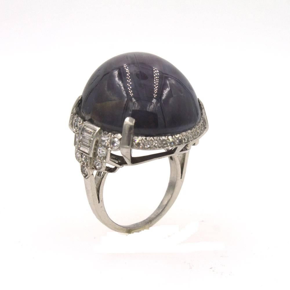 This Magnificent Star Sapphire is approximately 82 carats and is set in a gorgeous four prong diamond platinum mounting. The Art Deco mounting is just as exquisite as the sapphire and features approximately 1.0 CTTW of Old Euorpean, single cut, and