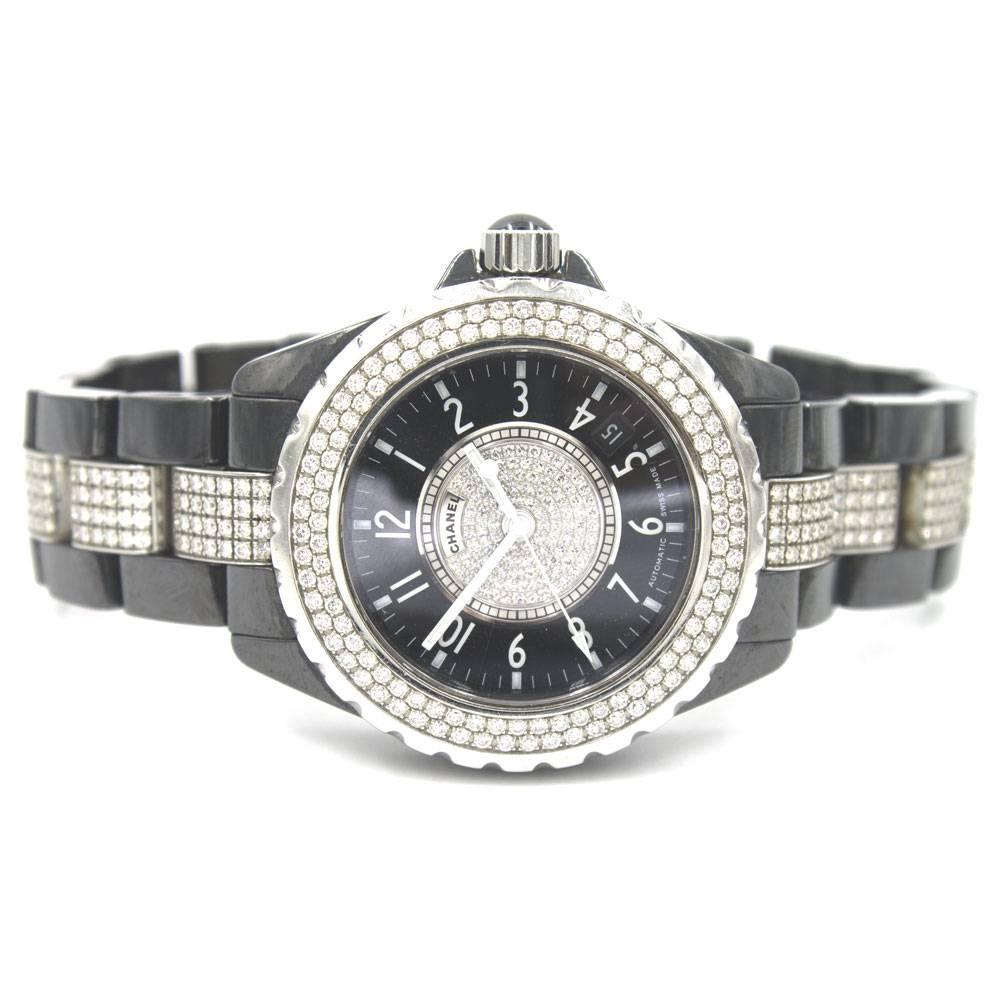 This modern designer watch by Chanel features a diamond dial with white hands, rotating diamond bezel, and black ceramic diamond bracelet. 
Reference Number LX 71957 
38mm Case
Quartz movement
200 meter water resistance

**Full One Year