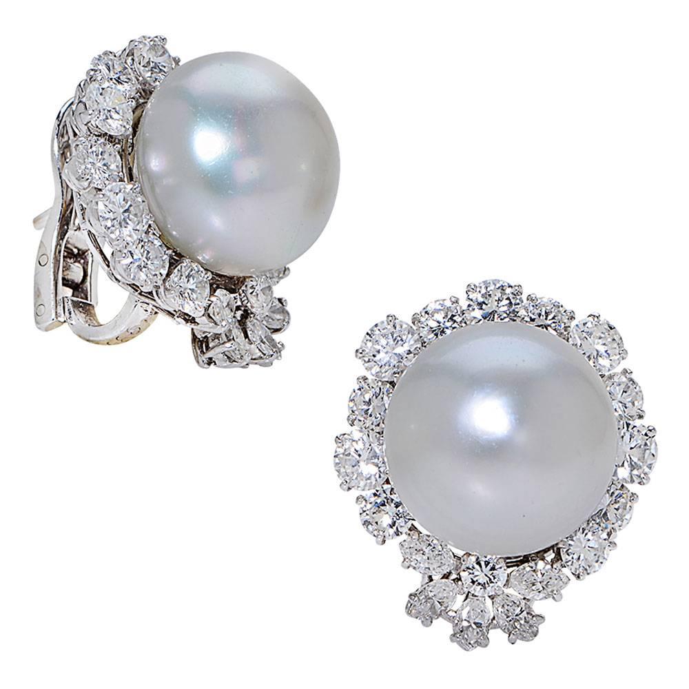 Luxury at its best! These timeless and elegant earrings designed by Van Cleef & Arpels feature 15mm South Sea Pearls surrounded by 5.50 cttw of round brilliant cut diamonds. The diamonds are DEF color and VS clarity. The back of the earrings are