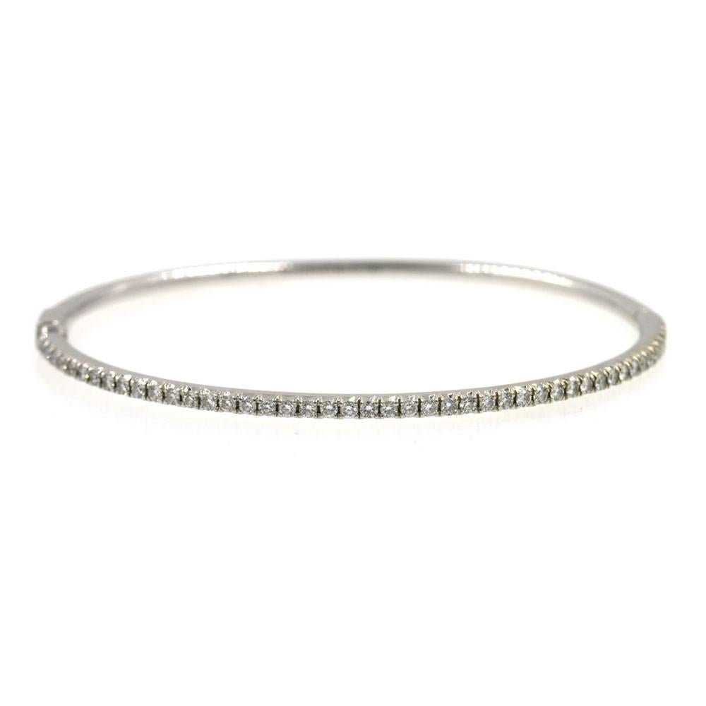 This timeless diamond bracelet by Tiffany & Company can be worn alone or stacked. There are 3/4 cttw of round brilliant cut diamonds across the top of the bangle which is fashioned in 18 karat white gold. The bracelet measures 2.5 inches in