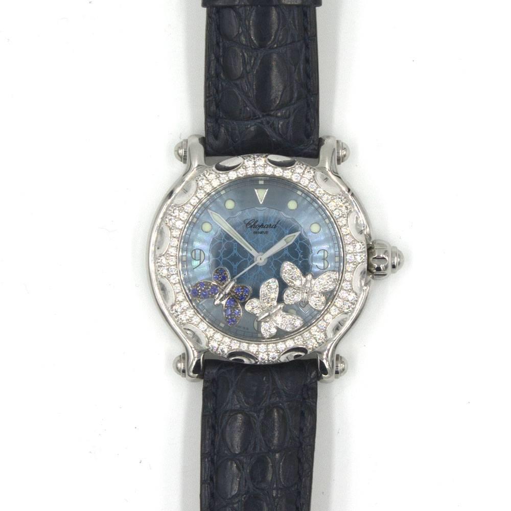 Stylish Chopard Happy Sport Diamond Watch comes with two straps ( black leather and blue rubber). Features a  blue mother of pearl dial, and three floating diamond and blue sapphire butterflies. The watch also features a diamond bezel, sapphire