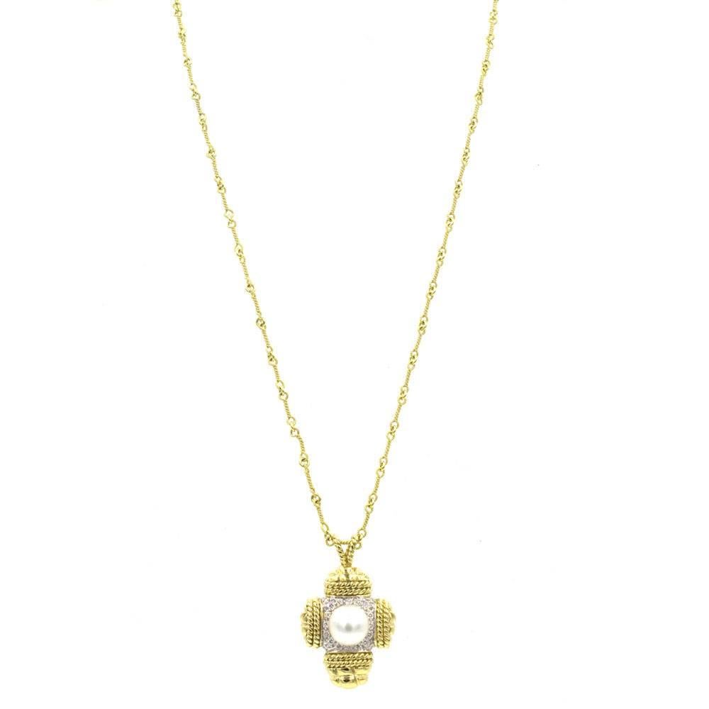 This classy and stylish diamond and white cultured pearl cross pendant, by high-end designer Cassis, is fashioned in 18 karat yellow gold. There are 22 high quality round brilliant cut diamonds that equal approximately .25 cttw. The pearl measures
