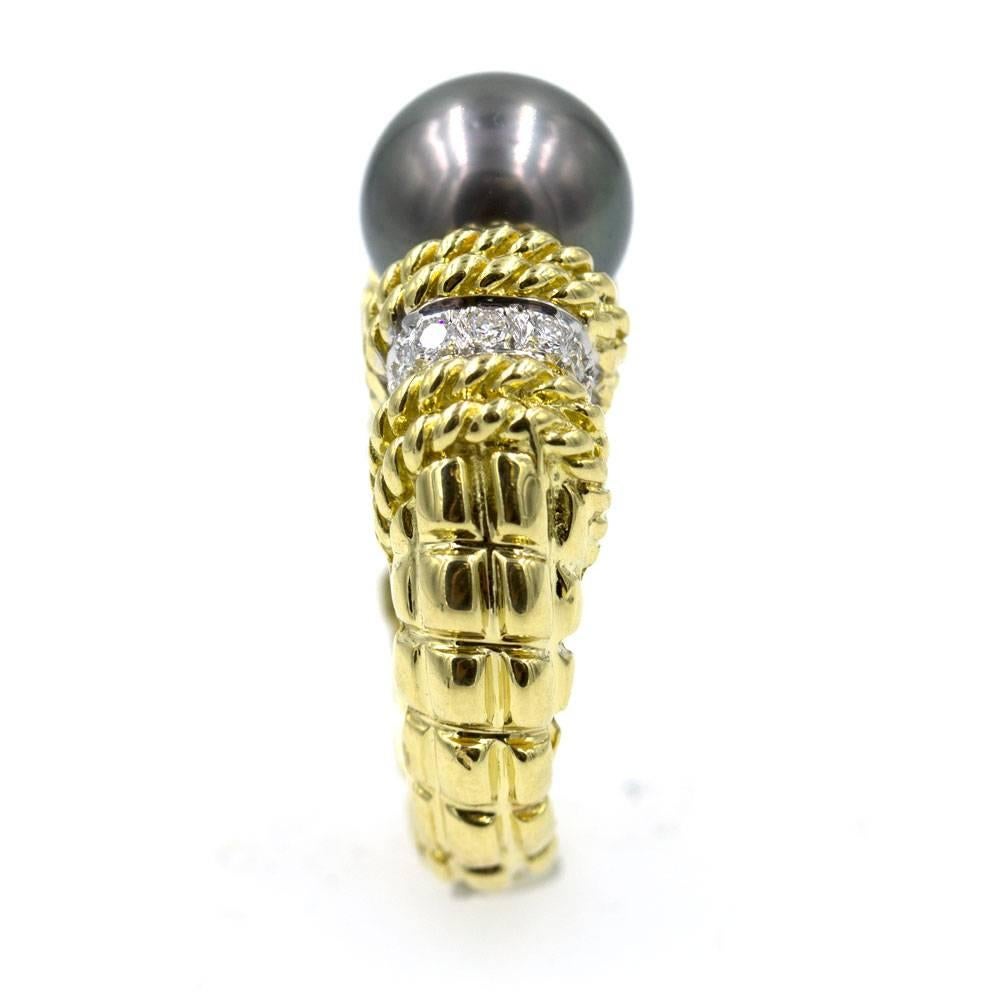 This classy and stylish diamond and black cultured pearl fashion ring, by high-end designer CASSIS, is fashioned in 18 karat yellow gold. There are 14 high quality round brilliant cut diamonds that equal approximately .28 cttw. The diamonds are