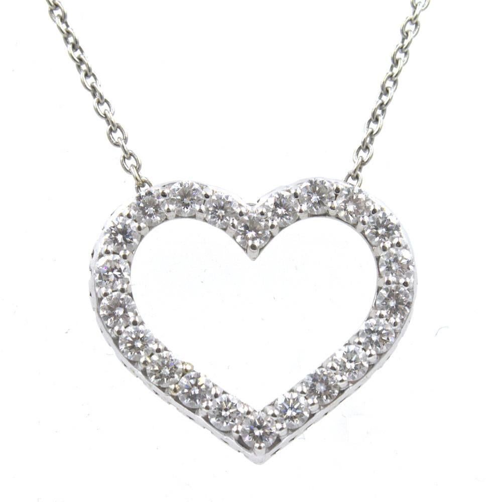 Luxurious diamond open heart pendant necklace by designer Roberto Coin. The pendant features 22 round brilliant cut diamonds graded G/H color and VS2 clarity. The pendant and chain are fashioned in 18 karat white gold and include Roberto Coin’s