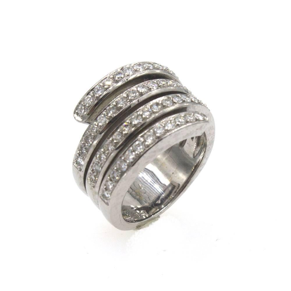 This fashionable spiral diamond band can be worn as a fashion ring or wedding/anniversary band. The 14 karat white gold ring features four rows of 54 round brilliant cut diamonds that equal approximately 1.5 cttw. At the widest point the ring