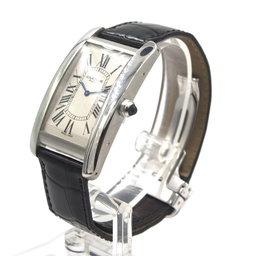 Platinum Cartier Tank American 

Cartier Tank American, large model Ref. W2604351.  Platinum case measuring approximately 45 x 26 mm, manual wind movement, natural blue spinel gemstone in the crown, scratch resistant sapphire crystal and 18-karat