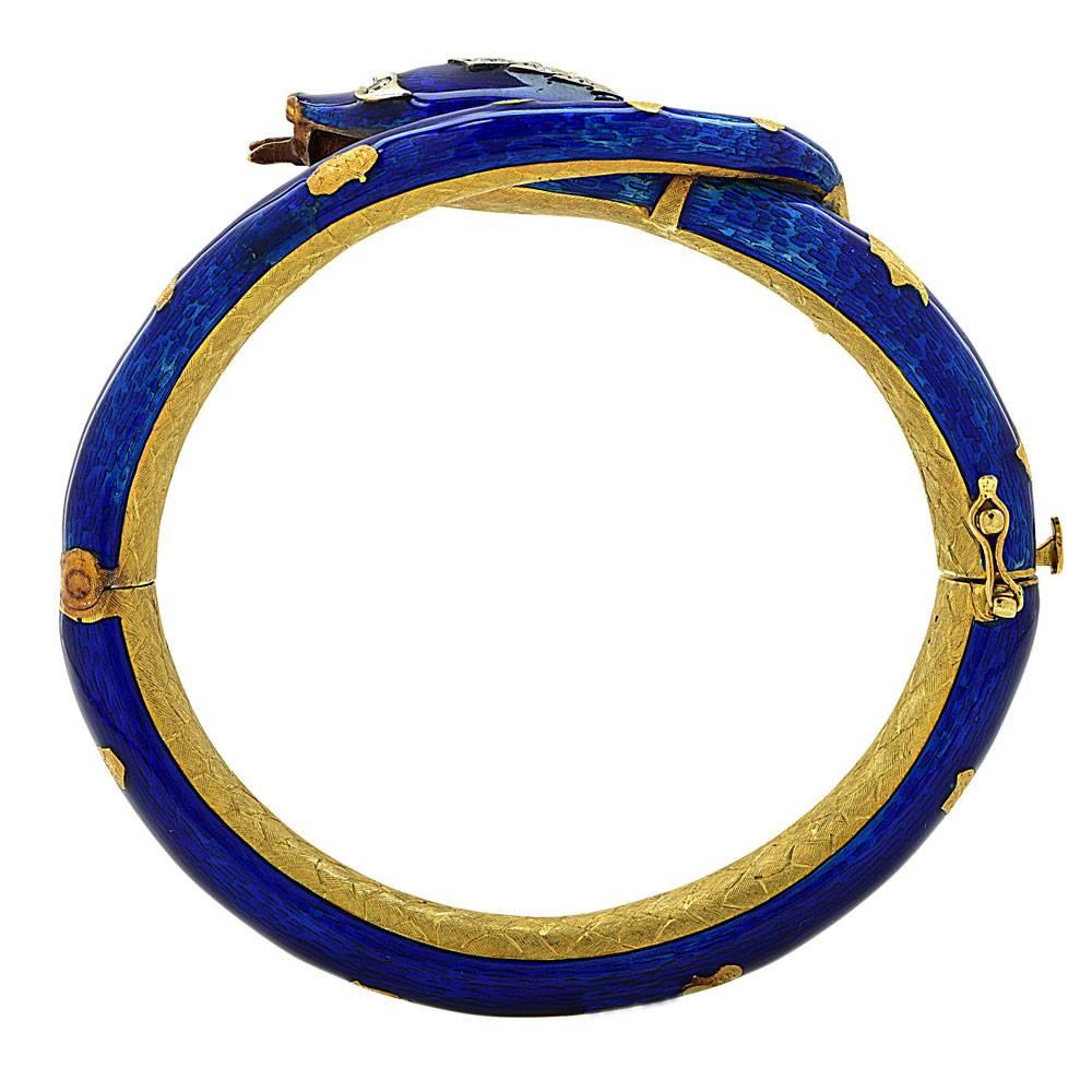This fabulous snake bracelet features amazing detail. The bangle is fashioned in 18 karat yellow gold, and blue enamel overlay. There are 5 round brilliant cut diamonds set on the head and eyes (equaling approximately .25 cttw). The bracelet is easy