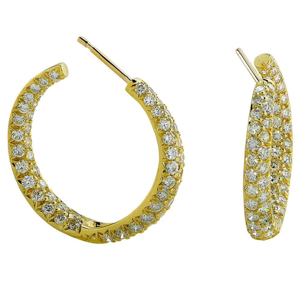 These stunning hoop earrings feature 3-carats of round brilliant diamonds set in an 