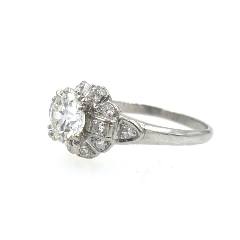 This beautiful diamond platinum engagement ring features an 1.0 carat Old European Cut Diamond graded I color and VS2 clarity. The platinum mounting also features 12 old European cut side diamonds which equal approximately .25 cttw. The ring has