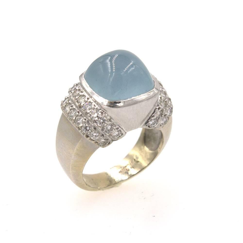 Beautiful modern moonstone and diamond ring by Marlene Stowe. The ring is fashioned in 18 karat white gold and features a large cabochon moonstone gemstone that measures approximately 13 x 13mm. Forty round brilliant cut diamonds line the sides of