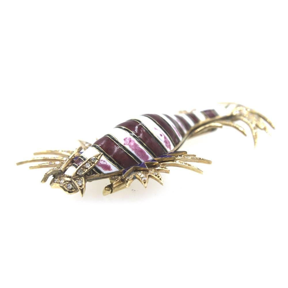 This catfish pin is fashioned in 14 karat rose gold, enamel, and diamonds.  The pin features 85 diamonds that equal approximately 1.25 cttw. The red and white enamel is in fabulous shape. 
The pin measures 3.5 inches in length from east to west.