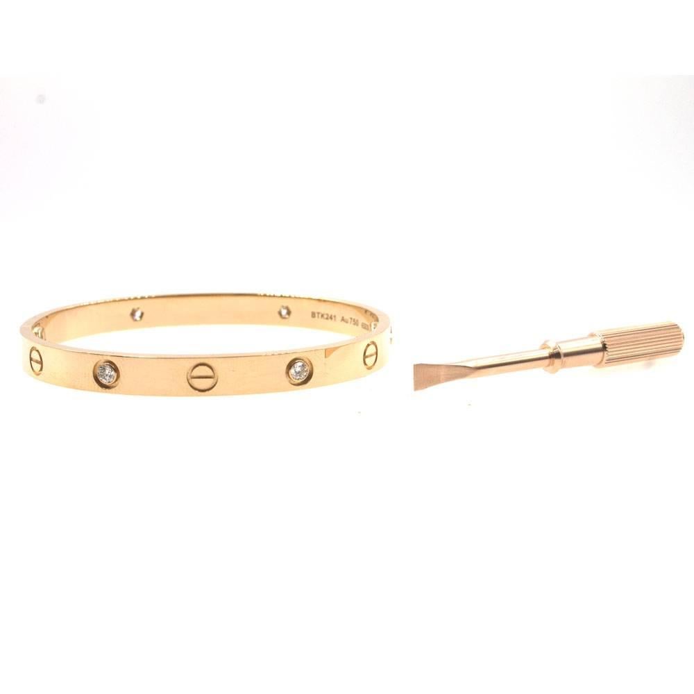 Cartier Four Diamond LOVE Bracelet fashioned in 18 karat rose/pink gold.  The size 17 bracelet is current model with new screw system, in great condition, and comes with screw driver and both inner and outer box. 100% Authenticity always
