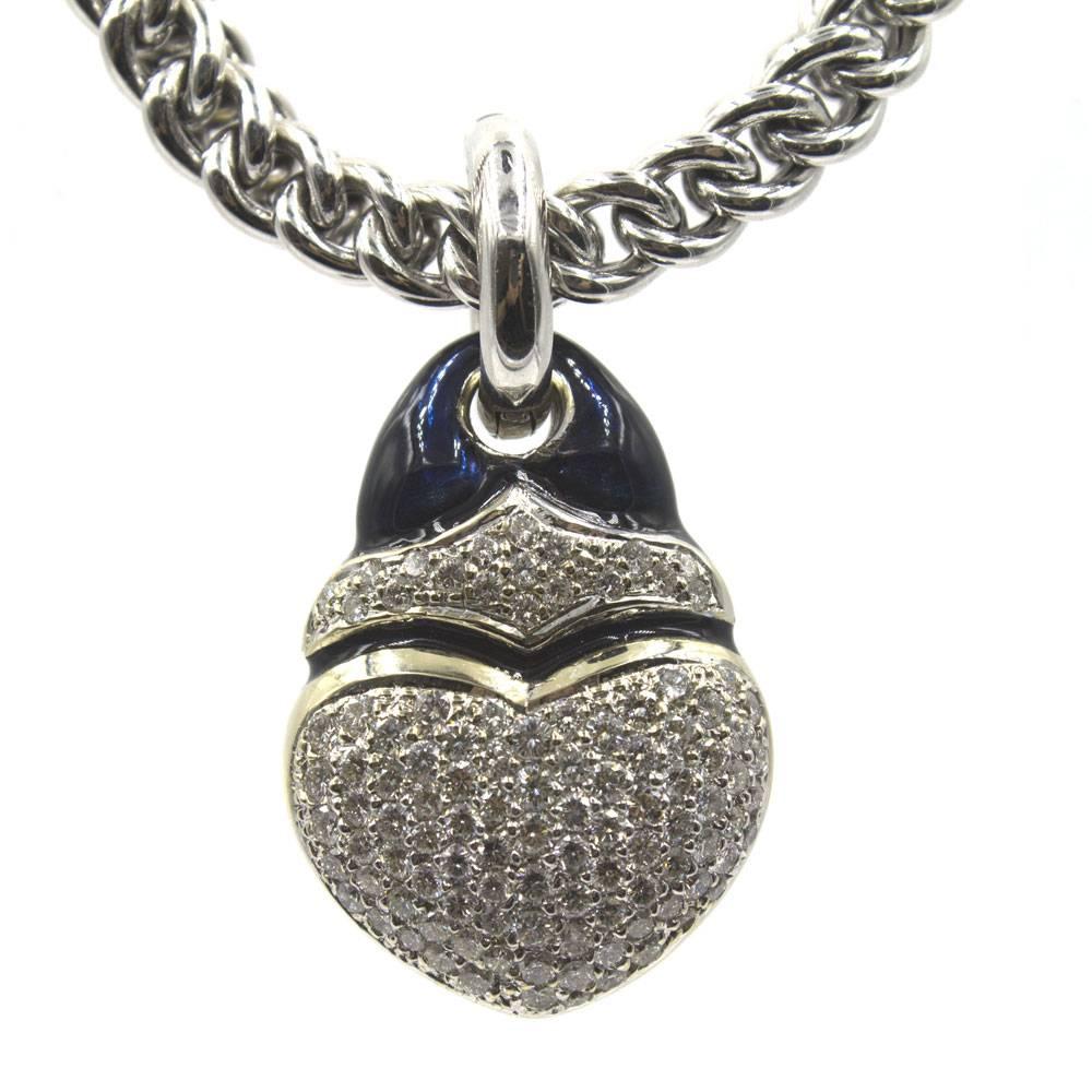 Stylish diamond heart pendant necklace by desiger SOHO. The heart pendant features 100 round briliant cut diamonds equaling 3.0 cttw. The pendant and link gold chain each feature black enamel accents. The necklace measures 16.5 inches, and is 6mm