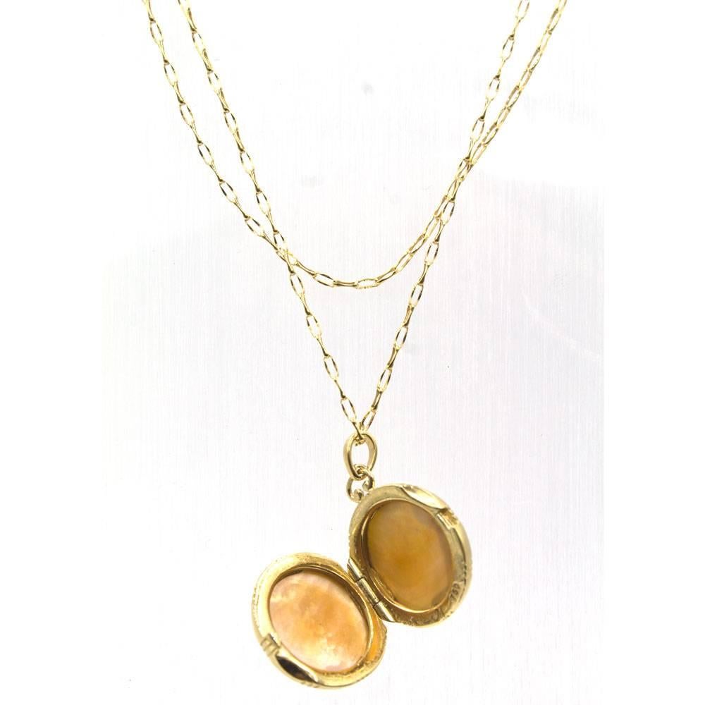 Beautiful double sided honey quartz locket by designer Monica Rich Kosann. The locket is fashioned in 18 karat yellow gold and features honey quartz gemstone over mother of pearl. The locket measures 19mm in diameter, and the chain is 30 inches in
