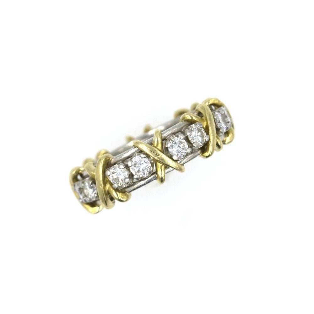 This classic 'Sixteen Stone' wedding band was designed by Jean Schlumberger for Tiffany & Company. The eternity band is beautifully crafted in 18 karat yellow gold, platinum and approximately 1.20 carats of high-quality diamonds. The ring is