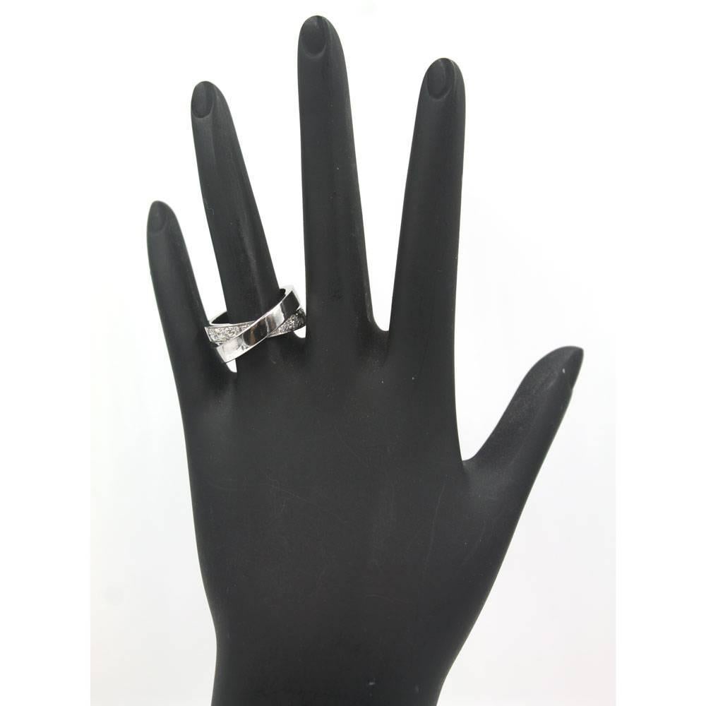 Beautiful diamond Nouvelle Bague band by Cartier circa 1999. The crossover design features approximately 1.00 carat total weight of diamonds. The band is size 53 (US size 6.5),  is numbered J22.., and is signed Cartier 750 c 1999.