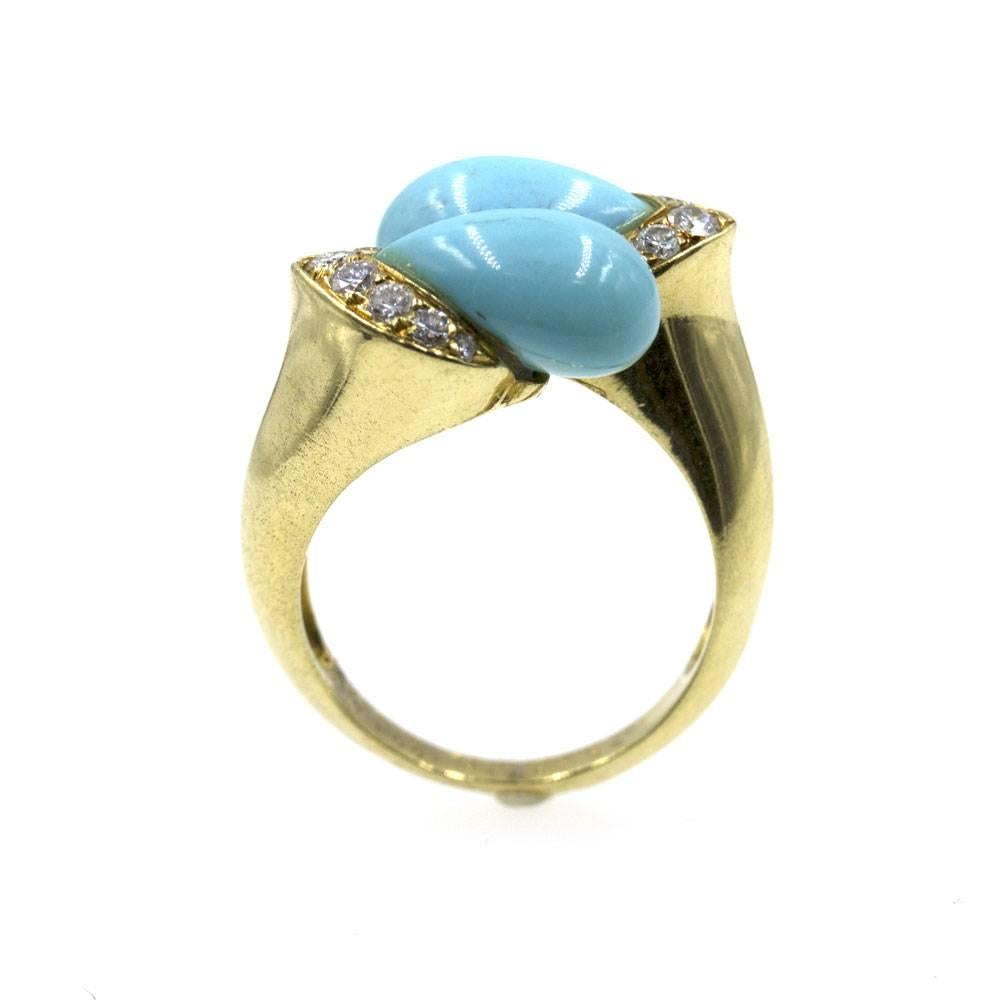 Fabulous 1960's diamond and turquoise ring by Van Cleef & Arpels. The gorgeous robin blue turquoise gemstones are set in a bypass fashion with 8 diamonds on each end, for a total of 16 diamonds (.50 cttw). The ring is beautifully crafted in 18