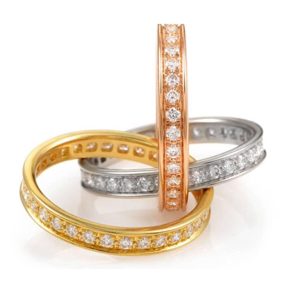 This stylish diamond trinity band ring by Cartier features 3 diamond interconnected bands. The bands are white, yellow, and rose 18 karat gold. In total there are approximately 1.55 cttw of diamonds graded F/VS1. The ring is size 5.25 (50) and can