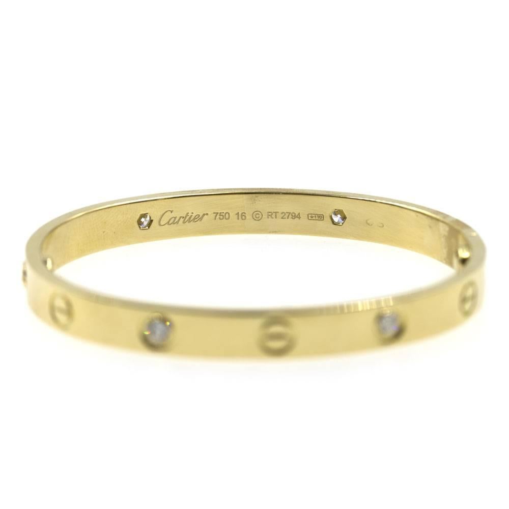 This stylish Authentic Cartier Love Bracelet with four diamonds is crafted in 18 karat yellow gold. This bracelet is size 16, and measures 2 inches in diameter. The bracelet comes with screwdriver and Cartier box. Signed Cartier 750 16 and numbered