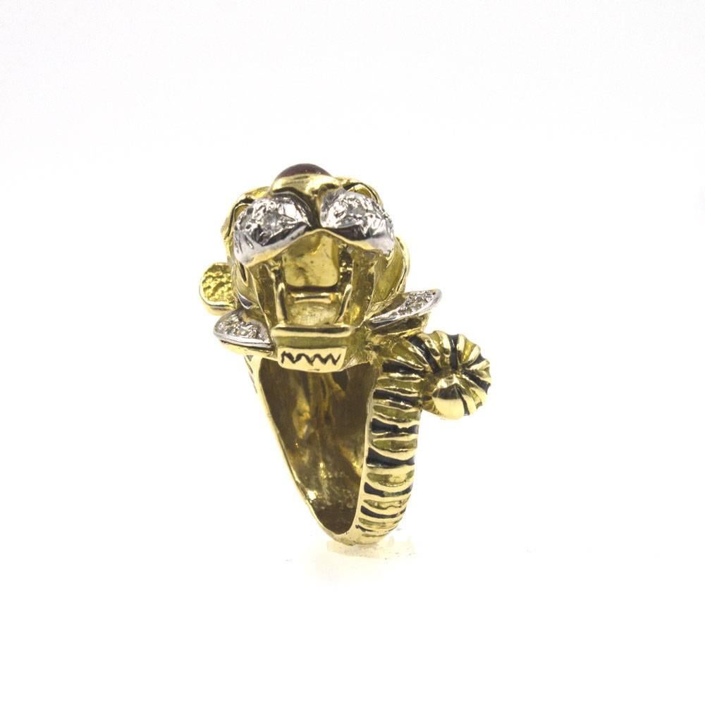 This fabulous Tiger Ring features round brilliant cut diamonds and black/red enamel. The ring is beautifully crafted in 18 karat yellow gold and overlays of colorful enamel. There are also 13 round brilliant cut diamonds that enhance the face. The