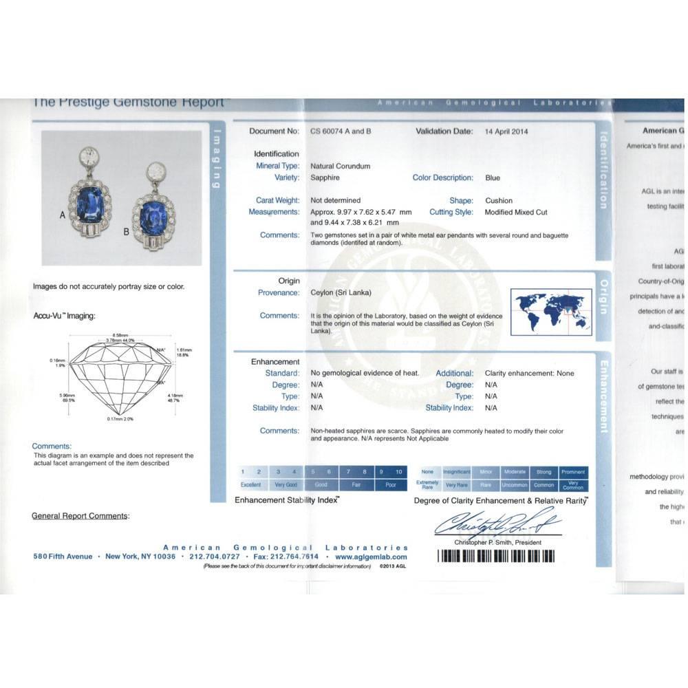 Stunning No Heat Sapphire Diamond Drop Earrings fashioned in platinum. These exquisite earrings feature two cushion shaped No Heat Ceylon Sapphires that have an AGL Certificate. The 4.49 and 3.91 carat blue sapphires are surrounded by 28 round
