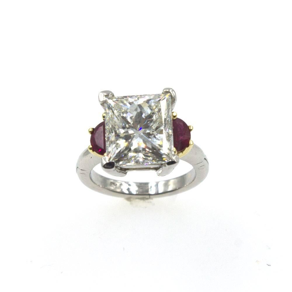This exquisite 6.22 carat diamond ring is set with two half moon shaped ruby gemstones in a platinum and 18 karat yellow gold mounting. The 6.22 carat princess cut diamond has been certified by the GIA and is graded J color and VS2 clarity. GIA