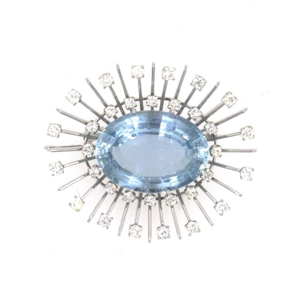 This fabulous 1960's spray pin features an approximately 18.5 carat aquamarine gemstone surrounded by a spray of 32 diamonds. The diamonds equal approximately 2.25 cttw. The high quality faceted aquamarine measures 17 x 25 x 9.5mm. Overall the pin