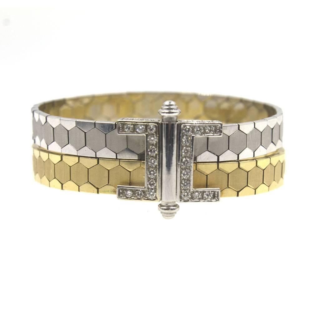 This fabulous vintage 18 karat two-tone gold bracelet features hexagon shaped links and a beautiful diamond clasp. Twenty four round brilliant cut diamonds are set on each side of the clasp for a total of approximately .50 cttw. The bracelet