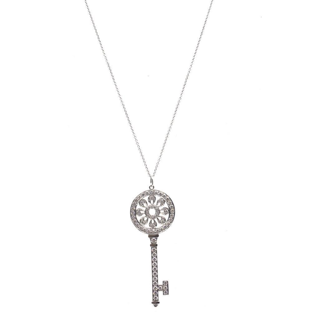 Tiffany & Company's signature large diamond petal key pendant fashioned in platinum. The Tiffany Key is known to symbolize a bright future, and is set with approximately 1.18 cttw round brilliant cut diamonds. The key measures 2.25 inches in length,