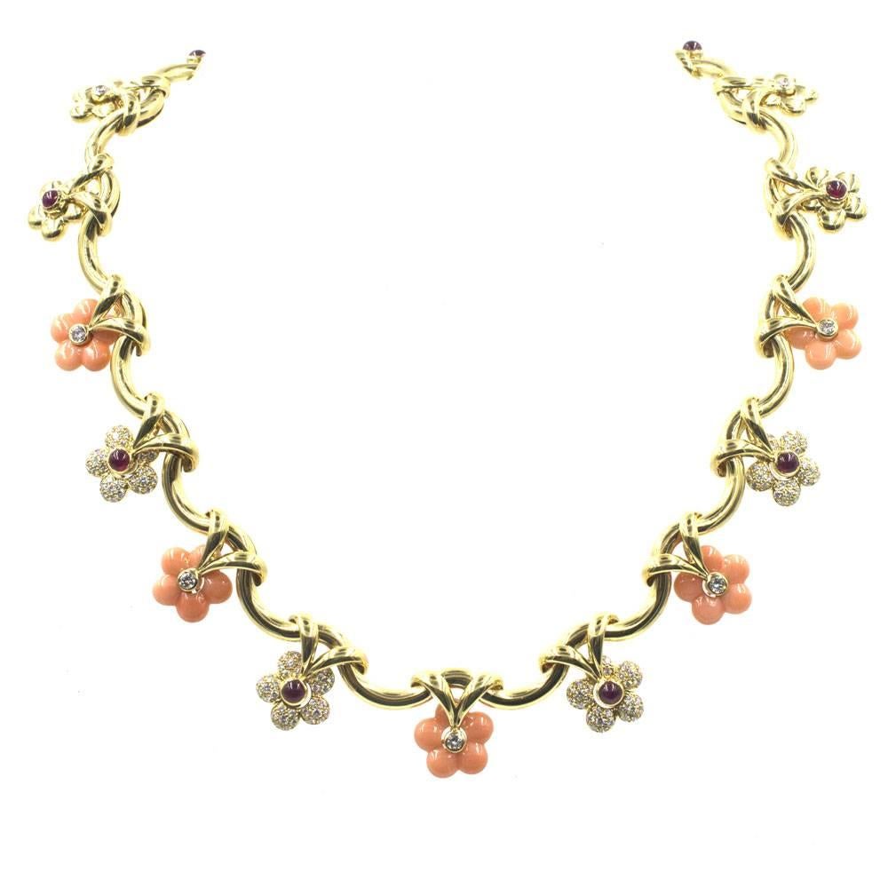 This beautifully crafted floral necklace features diamonds, rubies, and coral gemstones all fashioned in 18 karat yellow gold. The estate necklace was made in France and features French hallmarks. There are approximately 2.39 carat total weight of