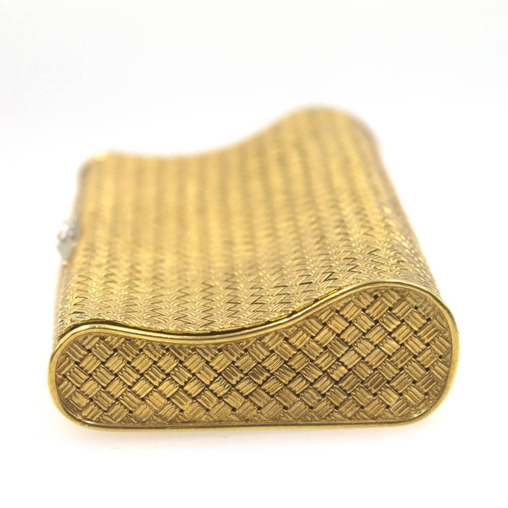 Vintage 18 karat yellow gold and diamond cigarette case. The case features 3 diamonds on the clasp, and a textured basket weave pattern. The case measures 2 x 3.5 inches. 