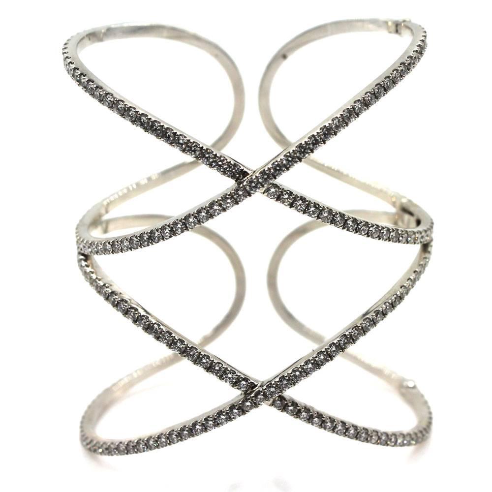 This gorgeous wide diamond cuff bracelet was designed by Dena Kemp. The wide hinged cuff features approximately 8.71 carat total weight of diamonds graded F/G color and VS clarity.   Fashioned in 18 karat white gold, the double X cuff measures 2.5