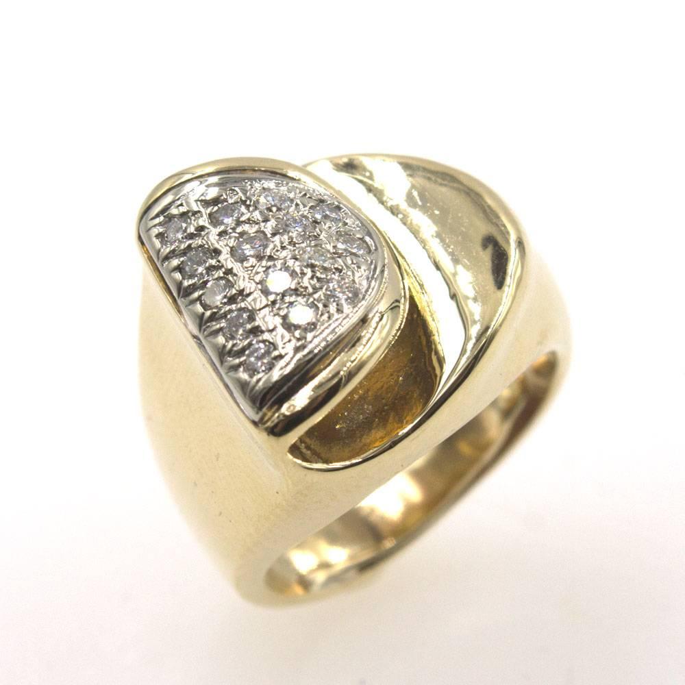 This stylish Retro ring features 15 round brilliant cut diamonds set in 14 karat yellow gold. The diamonds equal approximately .30 carat total weight. The ring is currently size 5( but can be sized). 