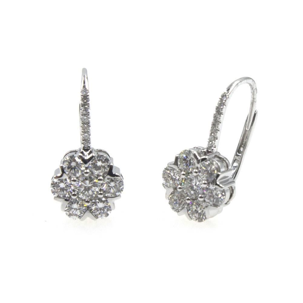 These stunning diamond cluster drop earrings are fashioned in 18 karat white gold. The 28 round brilliant cut diamonds are graded F-G color and VS clarity. The diamonds weigh approximately 2.03 carat total weight. The earrings measure .75 inches in