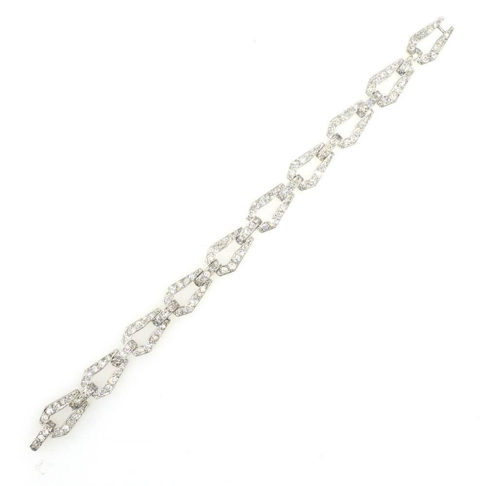 This beautiful 1940's diamond link bracelet is fashioned in platinum. The bracelet features 150 Old European and Transitional cut diamonds that equal approximately 6.50 carat total weight. The bracelet measures 7.1 inches in length and 4mm in width. 