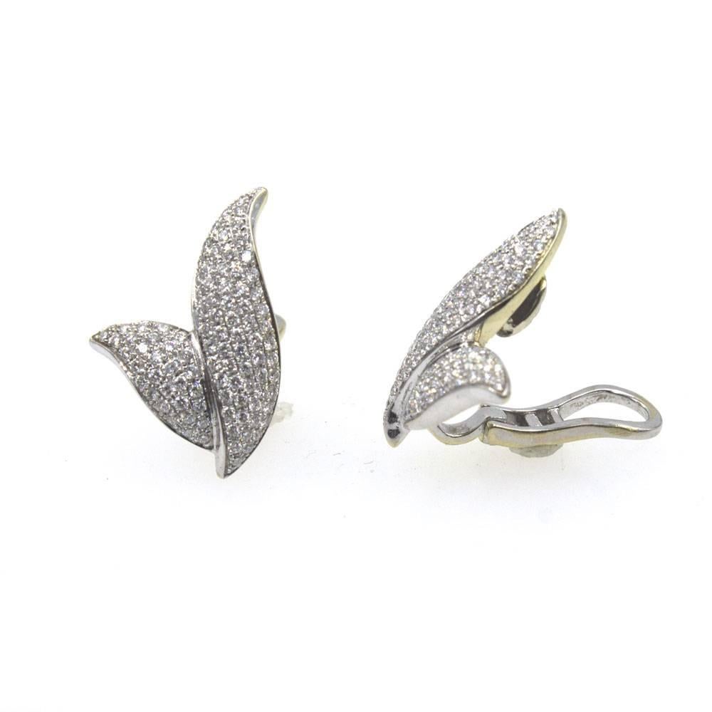Stylish diamond ear clips fashioned in 18 karat white gold. The earrings feature 2.00 carat total weight of round brilliant cut diamonds and measure .75 x 1.00 inches. 