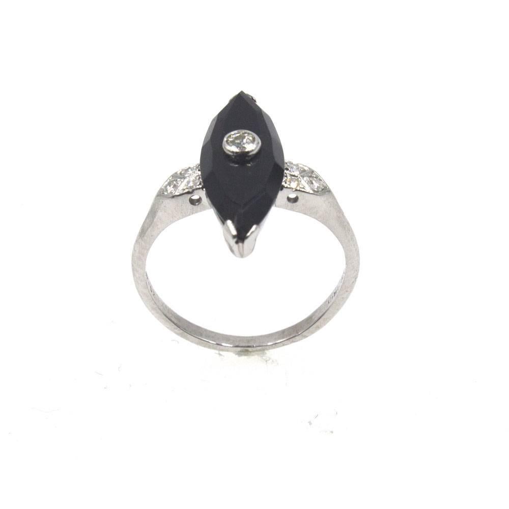 This beautiful late Deco ring features a marquise shaped onyx gemstone and .13 carats of diamonds. The original platinum mounting measures 7 x 19mm, and the ring is currently size 5 (can be sized). 