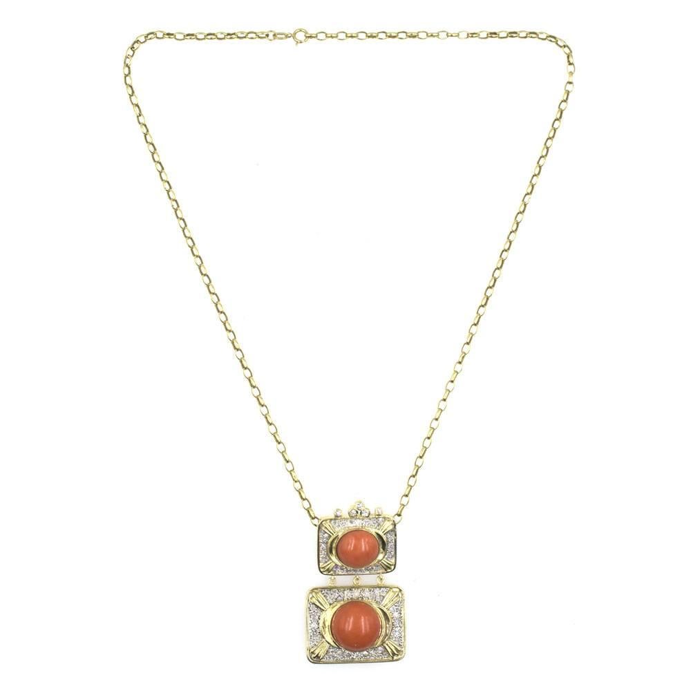 This stylish diamond and coral vintage pendant is fashioned in 18 karat gold. The swinging rectangular double drop pendant features 73 round brilliant cut diamonds that equal approximately 1.00 carat total weight. Each drop is crafted with diamonds