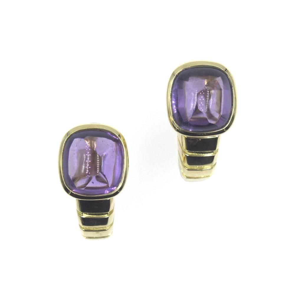 These beautiful estate earrings by Van Cleef & Arpels feature large cabochon amethyst gemstones. The amethysts are set into ribbed 18 karat yellow that tapers around to the back of the ear. The ear clips measure 1.0 inch from top to bottom(length)